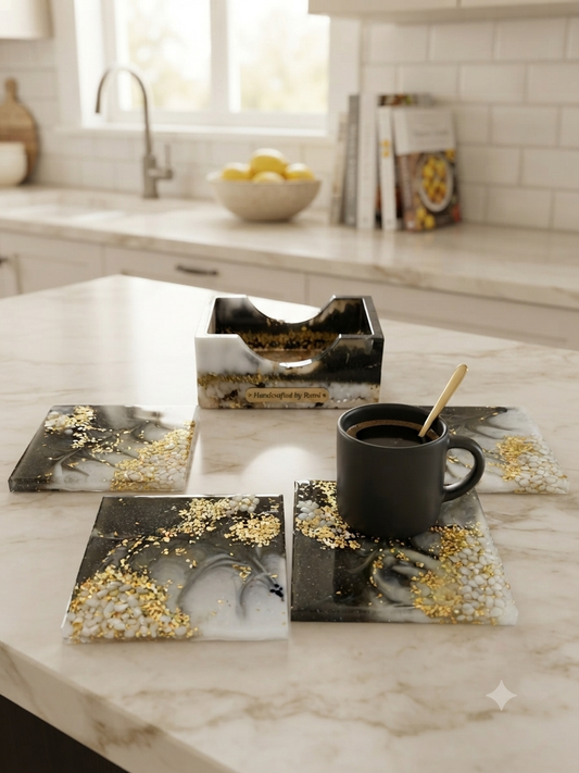 Handmade marble and gold leaf resin coasters with matching holder on a white kitchen counter, with a dark mug resting on one coaster